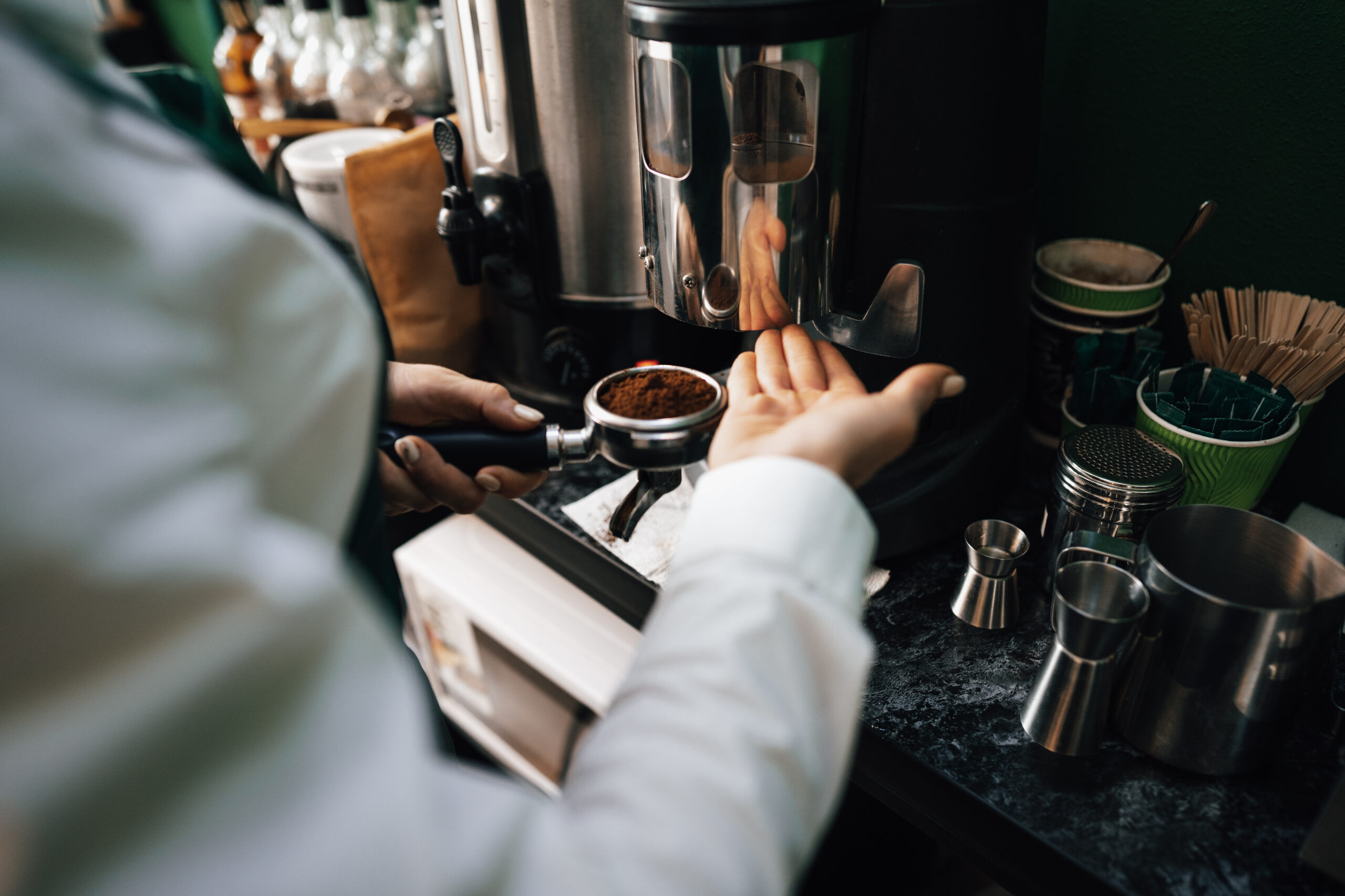 Close up photo of barista hands preparing coffee for customer in coffee shop